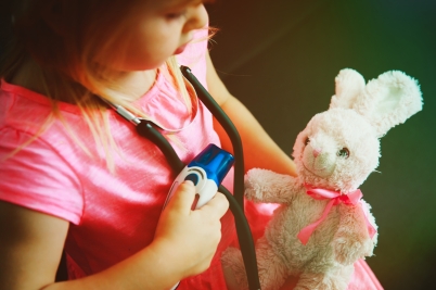 little girl play doctor or nurse with toy
